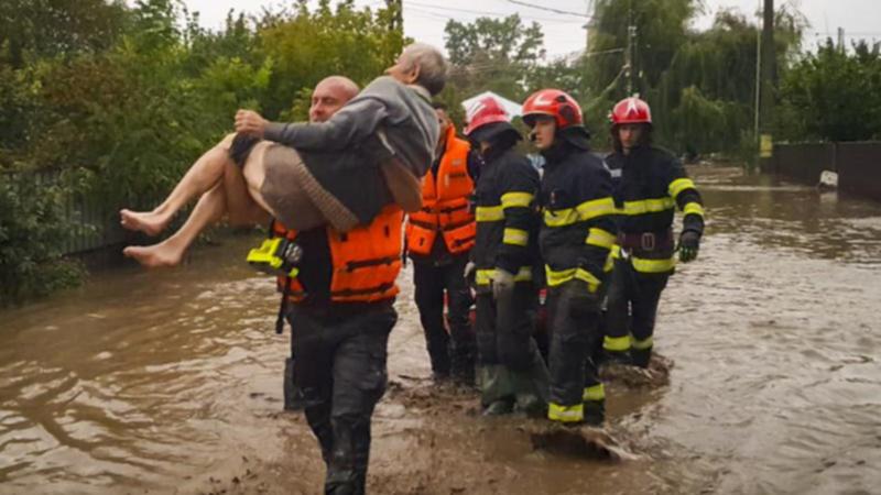 Torrential rain in Romania has killed at least four people and left scores stranded by flooding. (AP PHOTO)