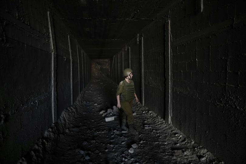 An Israeli soldier walks in a tunnel which the military says Hamas militants used in the southern Gaza Strip, about a 100 meters from the Philadelphi corridor along the border with Egypt.