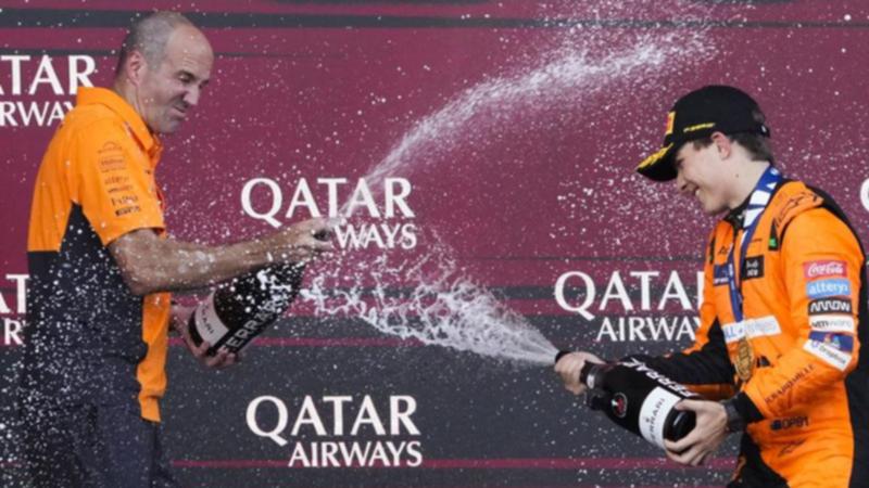 Oscar Piastri (right) sprays McLaren chief engineer Tom Stallard with champers after his Baku win.