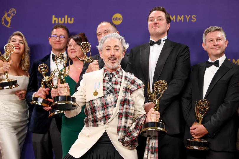 LOS ANGELES, CA - September 15, 2024 -  Alan Cumming (center), winner of the Outstanding Reality Competition Program for "The Traitors," in the trophy room at the 76th Primetime Emmy Awards at the Peacock Theater on Sunday, September 15, 2024 (Jason Almond / Los Angeles Times via Getty Images)