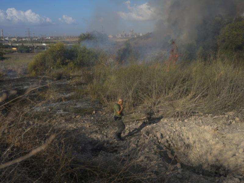 A police officer inspects damage