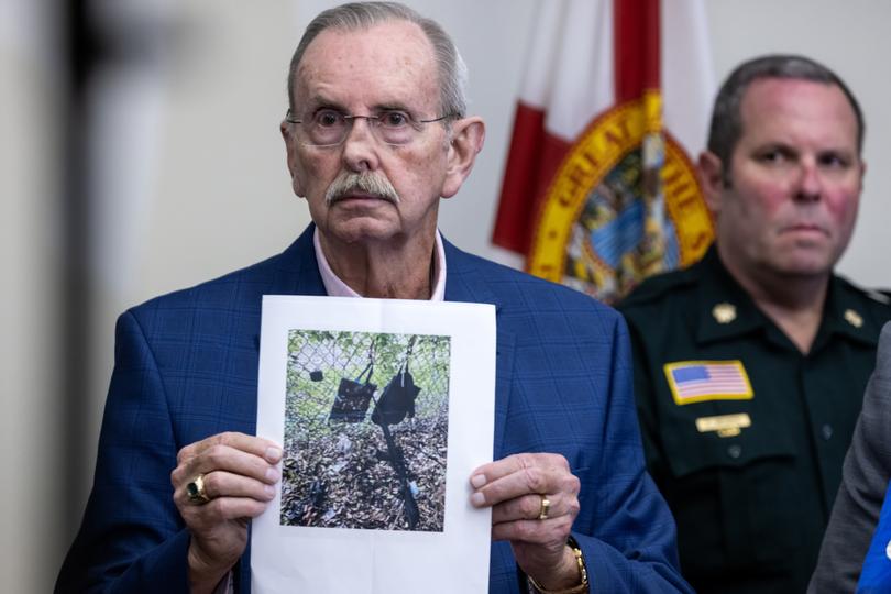 Sheriff Ric L. Bradshaw shows a picture of an AK-style rifle with a scope, and bags found by the Secret Service at the Trump International Golf Club.