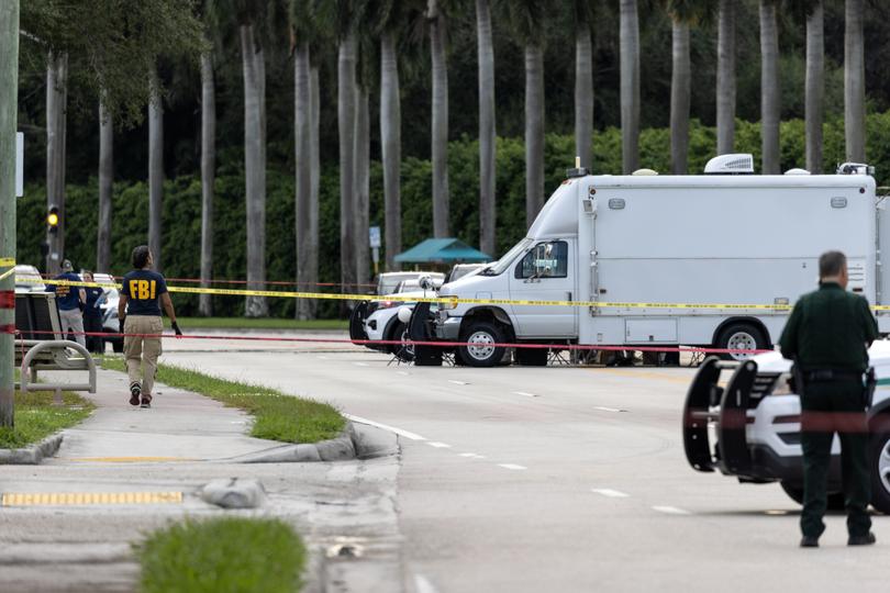 Palm Beach Sheriff officers guard the rear entrance of the Trump International Golf Club.