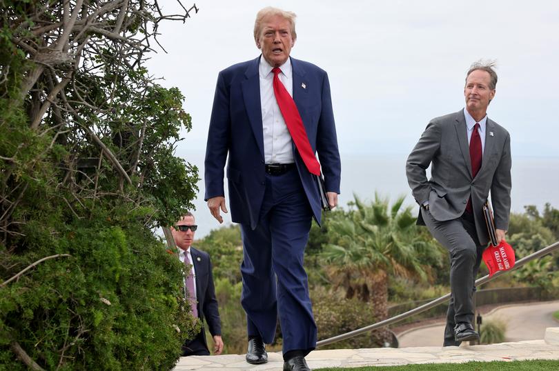 RANCHO PALOS VERDES, CALIFORNIA - SEPTEMBER 13: Republican presidential nominee, former U.S. President Donald Trump (C) walks with Rancho Palos Verdes Mayor John Cruikshank (R) before a press conference at Trump National Golf Club Los Angeles on September 13, 2024 in Rancho Palos Verdes, California. Trump delivered remarks and answered questions from reporters at the event a day after announcing he will not take part in a second debate with Democratic presidential nominee, U.S. Vice President Kamala Harris. (Photo by Mario Tama/Getty Images)