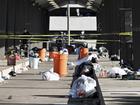 Officers stand behind police tape at the scene of the tailgating spot shooting in Detroit.