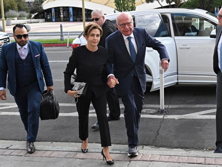 Rupert Murdoch, center, and his wife Elena Zhukova Murdoch arrive at the Second Judicial District Court in Reno, Nev., Monday Sept. 16, 2024. (AP Photo/Andy Barron) Andy Barron