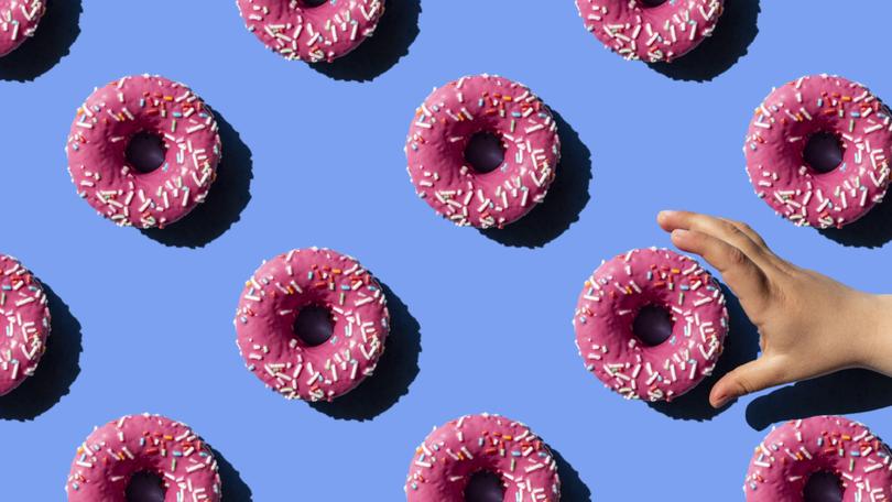 Pink doughnut on pastel blue background