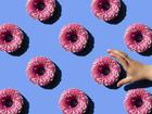 Pink doughnut on pastel blue background