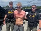 US police officers prepare to arrest Ryan Routh, the man suspected in the apparent assassination attempt of Donald Trump.