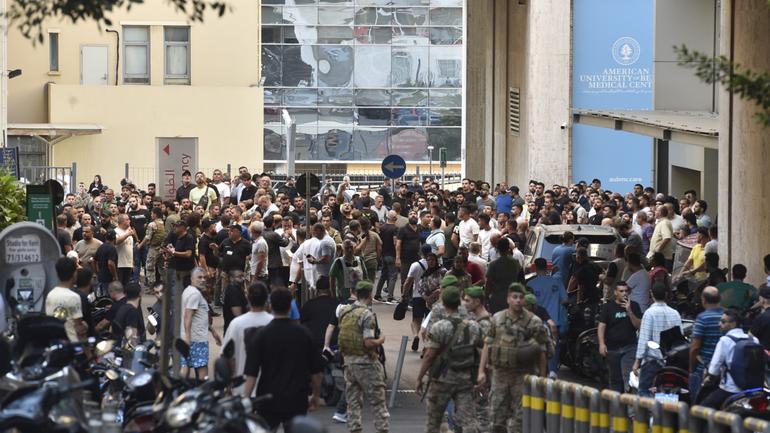 Lebanese soldiers and Hezbollah members gather outside the American University of Beirut Medical Center (AUBMC) after an incident involving Hezbollah members' wireless devices in Beirut, Lebanon.