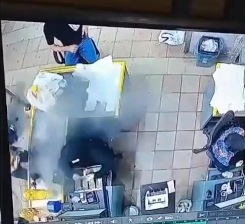 CCTV footage shows the moment a pager explodes in somebody's pocket while shopping. 