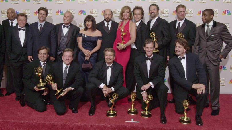 The cast and producing staff of "The West Wing" appear backstage with the Emmys the show garnered, including best drama series, at the 54th Annual Primetime Emmy Awards Sunday, Sept. 22, 2002, at the Shrine Auditorium in Los Angeles. (AP Photo/Reed Saxon)