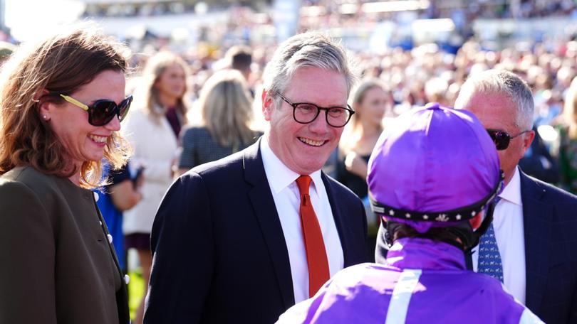 Prime Minister Keir Starmer and wife Victoria Starmer, left, speaks to jockeys ahead of the Betfred St Leger Stakes.