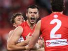 Logan McDonald of the Swans celebrates with teammates after kicking a goal.