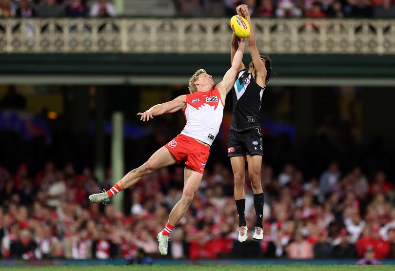 SYDNEY, AUSTRALIA - SEPTEMBER 20: Isaac Heeney of the Swans and Jase Burgoyne of the Power compete for the mark during the AFL Preliminary Final match between Sydney Swans and Port Adelaide Power at Sydney Cricket Ground, on September 20, 2024, in Sydney, Australia. (Photo by Cameron Spencer/Getty Images)