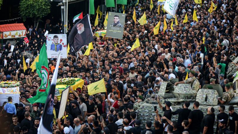 Hezbollah supporters carry the coffin of a victim who was killed in electronic pagers explosion, during a funeral procession in Beirut southern suburb. Thousands people were wounded in the cyberattack and 12 were killed so far in the latest toll announced by the ministry of health. 