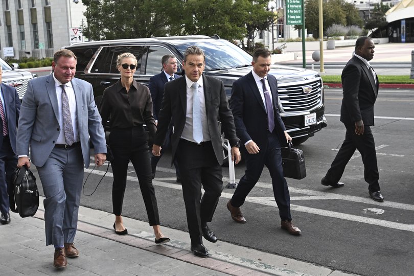 Lachlan Murdoch, center, and his wife Sarah arrive at the Second Judicial District Court in Reno, Nev., on Monday Sept. 16, 2024. (AP Photo/Andy Barron)