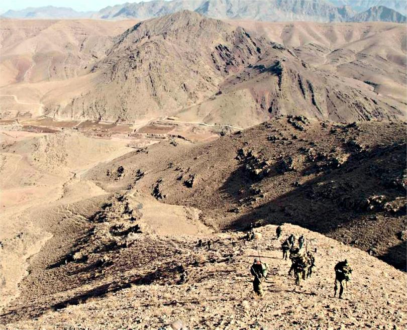 Special Forces members reach the summit of a gruelling peak in the Uruzgan mountains. 