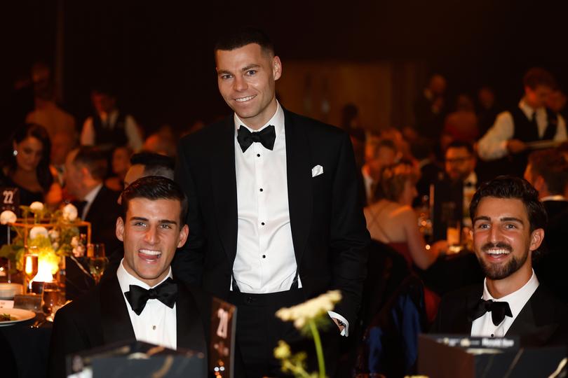 Nick Daicos, Jamie Elliott and Josh Daicos of the Magpies.