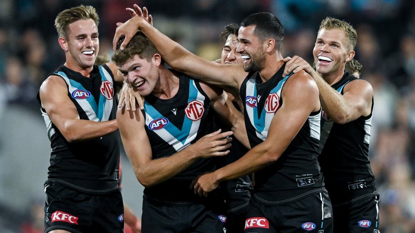 Mitch Georgiades celebrates a goal with Ryan Burton and Dan Houston.
