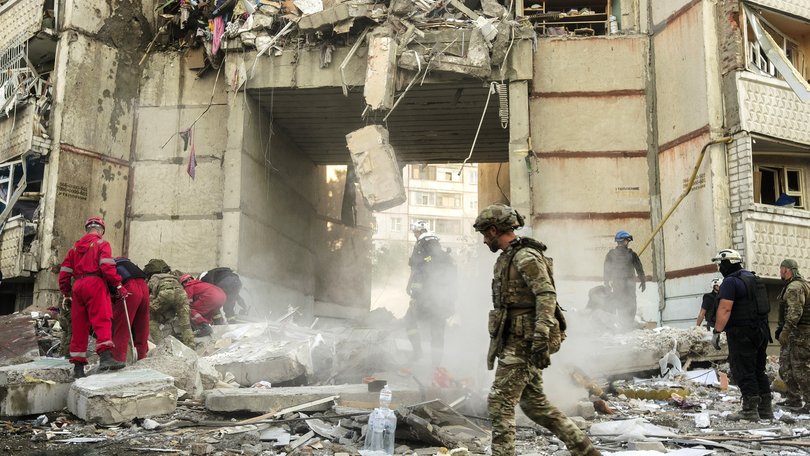 Ukrainian rescuers work at the site of a shelling on a high-storey residential building in Kharkiv, northeastern Ukraine, 24 September 2024, amid the ongoing Russian invasion. 