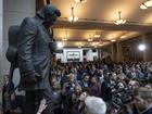 People crowd around after the unveiling of a bronze statue of Johnny Cash in Washington.