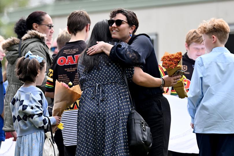 Mourners are seen prior to the funeral service at St Thomas Aquinas Church in Springwood.