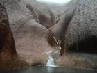 Heavy rain has lashed Uluru in central Australia, leaving water cascading to the ground. (HANDOUT/AAP)