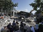 Residents and emergency workers arrive at the scene of an Israeli air strike in the town of Maisara, north of Beirut.