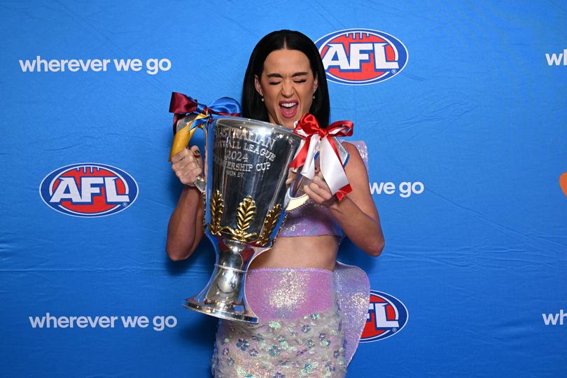 US pop superstar Katy Perry poses for photographs with the 2024 AFL Premiership trophy during a 2024 AFL Grand Final entertainment media preview at the MCG, in Melbourne, Thursday, September 26, 2024. (AAP Image/James Ross) NO ARCHIVING