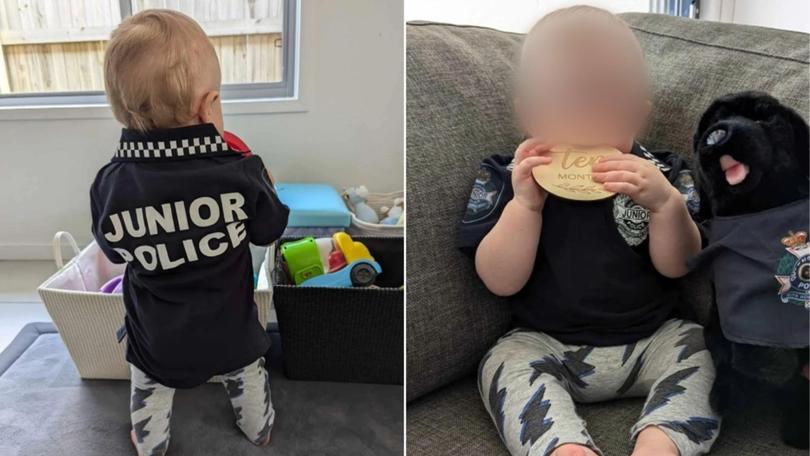 The young victim of the hot coffee attack in Brisbane wearing a police uniform gifted to him by the Queensland squad searching for his attacker.