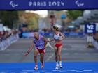 Mia Carol stumbles as he and Paralympian Elena Congost approach the finish line in the women’s T12 marathon.