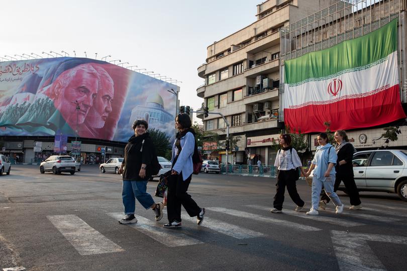 FILE — A billboard in Tehran depicts Qassim Suleimani, an assassinated Iranian general, and Ismail Haniyeh, the Hamas leader killed in Iran in July, on Aug. 25, 2024. Iran says Israel wants to trap it into a direct conflict by bombing Hezbollah, even as a new Iranian president tries outreach to the West. (Arash Khamooshi/The New York Times)