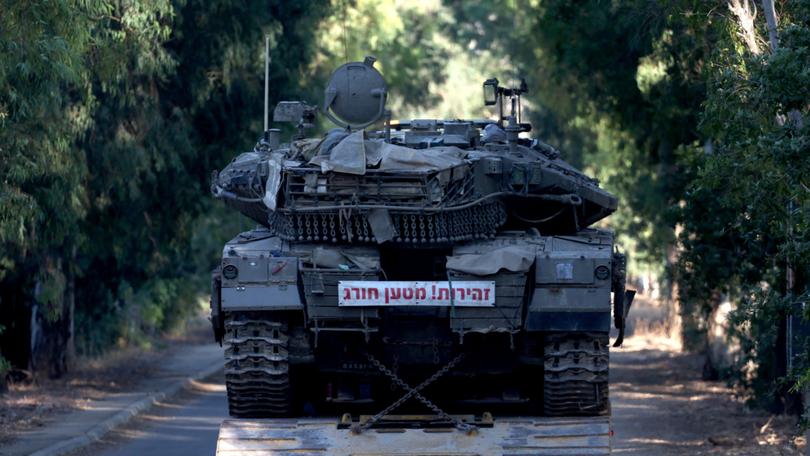 A truck carrying a tank moves toward Israel's northern border with Lebanon.