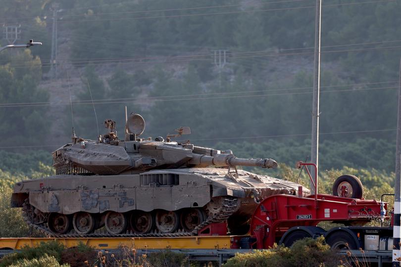 A truck carrying a tank moves towards Israel's northern border with Lebanon.