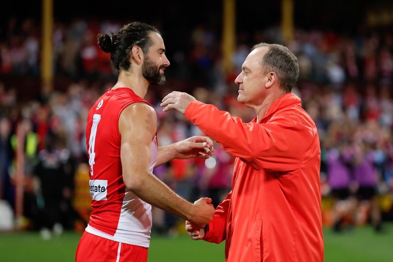 SYDNEY, AUSTRALIA - SEPTEMBER 20: Brodie Grundy of the Swans and John Longmire, Senior Coach of the Swans are seen during the 2024 AFL First Preliminary Final match between the Sydney Swans and the Port Adelaide Power at The Sydney Cricket Ground on September 20, 2024 in Sydney, Australia. (Photo by Dylan Burns/AFL Photos via Getty Images)