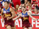 Lachie Neale celebrates winning the grand final.