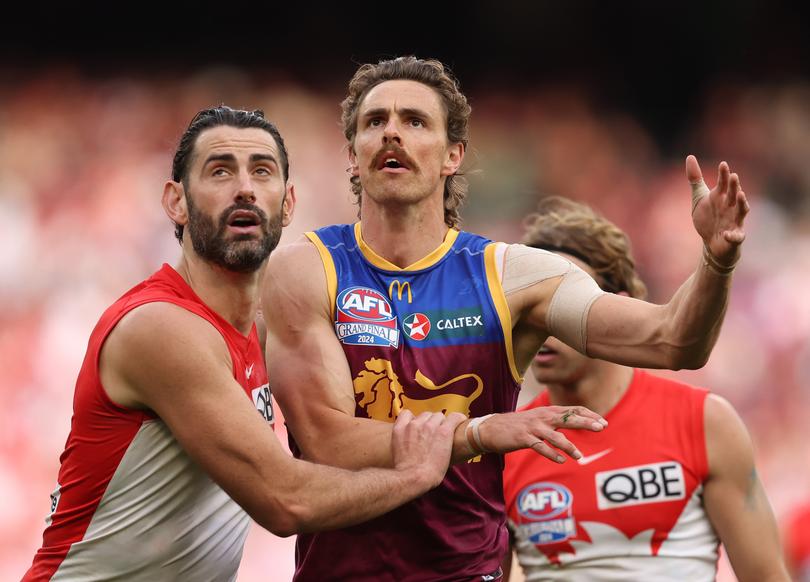 Brodie Grundy of the Swans and Joe Daniher of the Lions compete for the ball.