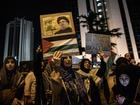 A woman holds a poster of Hezbollah leader Sayyed Hassan Nasrallah in front of the Israeli Consulate.