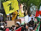 Attendees were seen waving a flag associated with Hezbollah at a pro-Palestine rally in Melbourne. (James Ross/AAP PHOTOS)