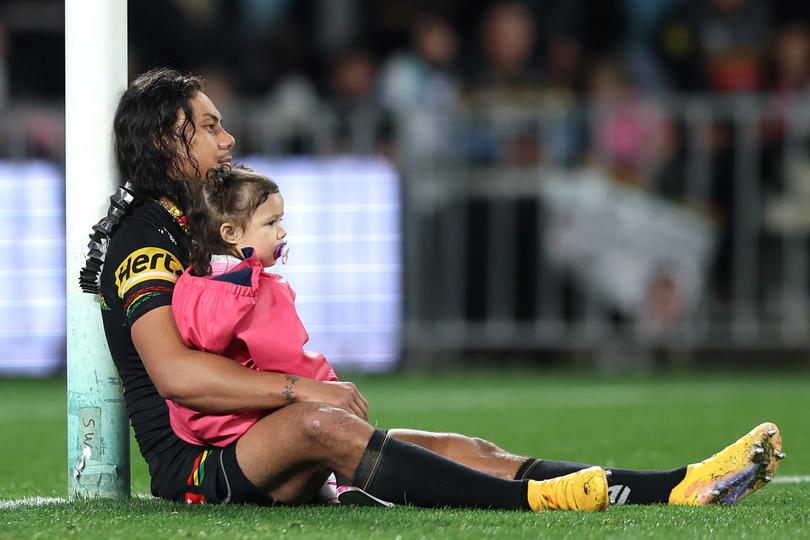 SYDNEY, AUSTRALIA - SEPTEMBER 28:  Jarome Luai of the Panthers sits with his daughter after winning the NRL Preliminary Final match between the Penrith Panthers and the Cronulla Sharks at Accor Stadium on September 28, 2024 in Sydney, Australia. (Photo by Mark Metcalfe/Getty Images)