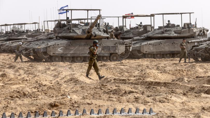 Israeli reservists on their tanks at a IDF staging area near the border of Gaza in southern Israel on May 21. MUST CREDIT: Heidi Levine for The Washington Post