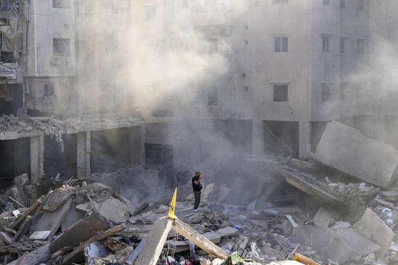 A man stands on the rubble of buildings near the site of the assassination of Hezbollah leader Hassan Nasrallah in Beirut's southern suburbs.