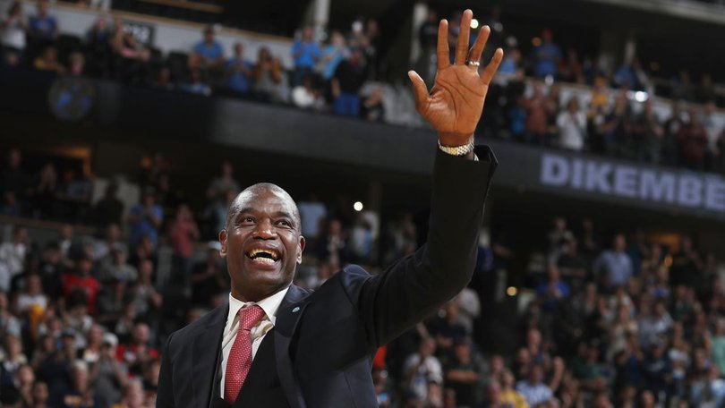 Dikembe Mutombo, waving to fans as his jersey number was retired by the Denver Nuggets, has died. (AP PHOTO)