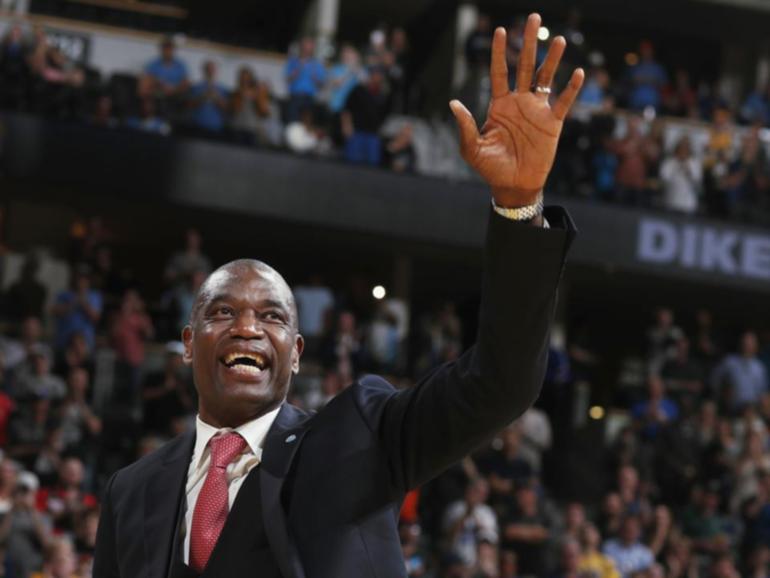 Dikembe Mutombo, waving to fans as his jersey number was retired by the Denver Nuggets, has died. (AP PHOTO)