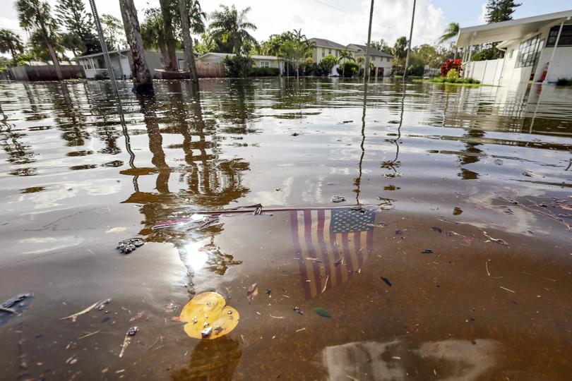 An American flag sits in floodwaters in the aftermath of Hurricane Helene.