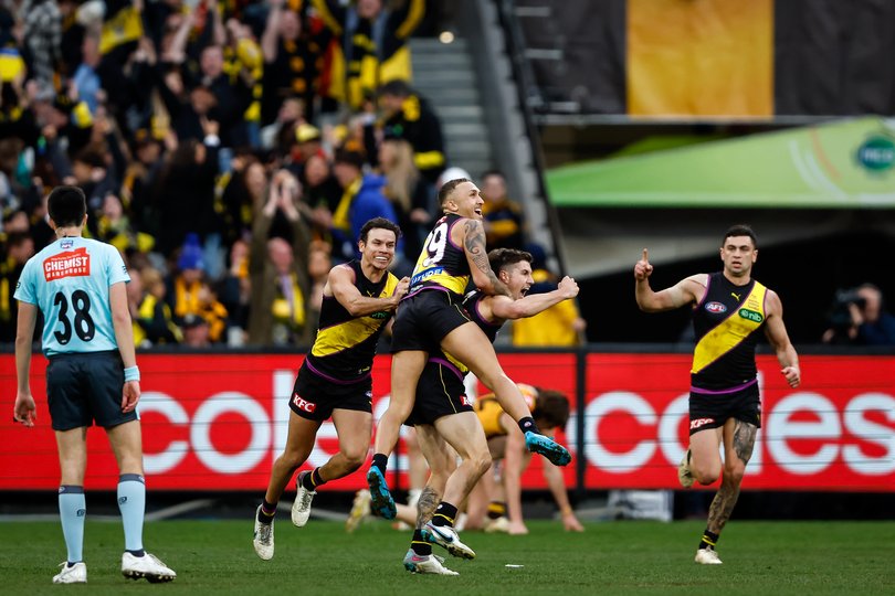 MELBOURNE, AUSTRALIA - JULY 22: Liam Baker of the Tigers celebrates a match winning goal with teammates Shai Bolton and Daniel Rioli during the 2023 AFL Round 19 match between the Richmond Tigers and the Hawthorn Hawks at the Melbourne Cricket Ground on July 22, 2023 in Melbourne, Australia. (Photo by Dylan Burns/AFL Photos)