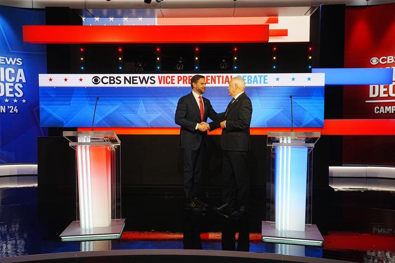 The two shake hands before the debate.