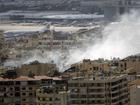 A plane prepares to take off from Beirut's airport as smoke rises after an Israeli airstrike. (