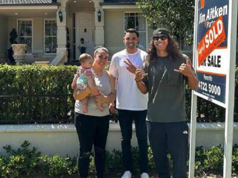 Bailey Paris Toleafoa and baby Halo, buyer's agent Thomas Tamine and Jarome Luai after the purchase of their South Penrith home.